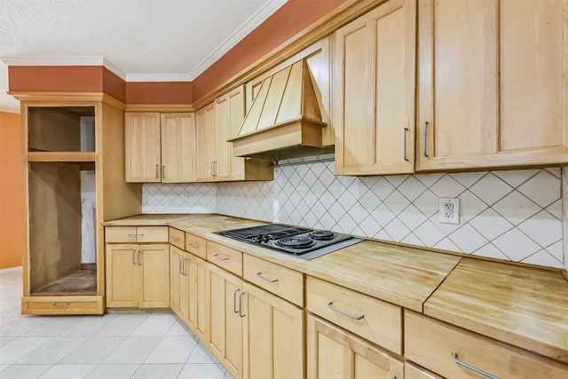 9402 Stockport Dr, Spring, TX 77379 - kitchen featuring premium range hood, light brown cabinets, butcher block counters, black electric cooktop, and decorative backsplash
