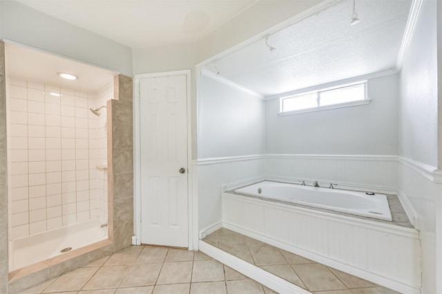 9402 Stockport Dr, Spring, TX 77379 - full bath featuring a garden tub, tile patterned floors, a tile shower, wainscoting, and ornamental molding