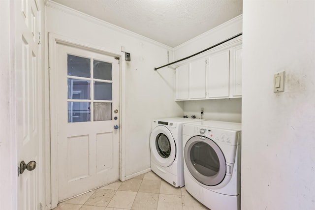 9402 Stockport Dr, Spring, TX 77379 - laundry area with washing machine and clothes dryer, cabinet space, a textured ceiling, crown molding, and light tile patterned floors
