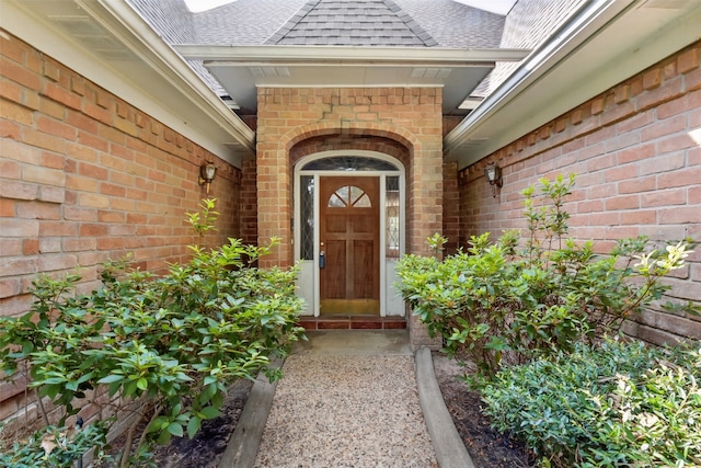 9402 Stockport Dr, Spring, TX 77379 - doorway to property featuring brick siding and a shingled roof