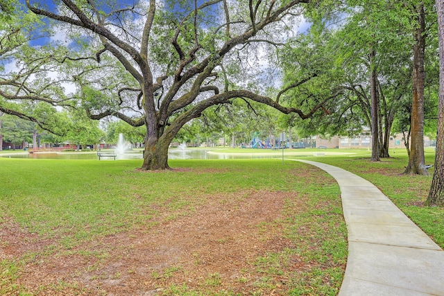 view of home's community featuring a lawn and a water view