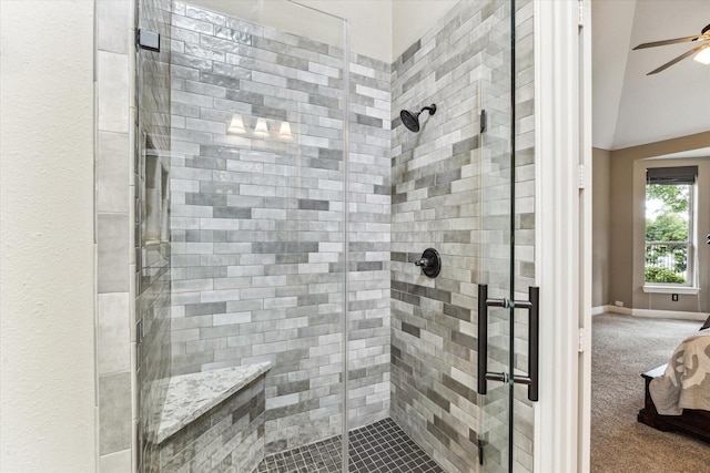 bathroom featuring ceiling fan and a stall shower