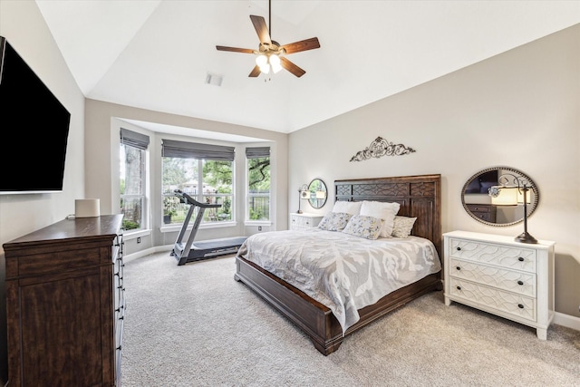 bedroom featuring ceiling fan, light colored carpet, high vaulted ceiling, baseboards, and visible vents