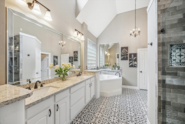 full bath with a sink, high vaulted ceiling, a tile shower, and a notable chandelier