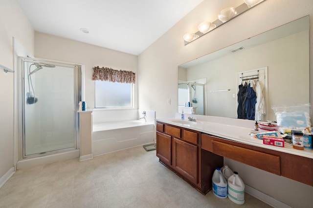 full bath with a shower stall, a garden tub, a walk in closet, vanity, and visible vents