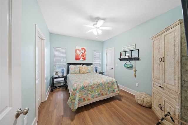bedroom featuring wood finished floors, baseboards, and ceiling fan