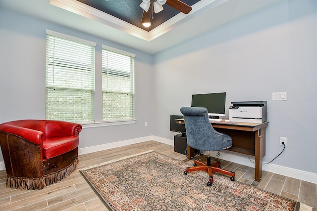 office space featuring crown molding, ceiling fan, wood finished floors, and a raised ceiling