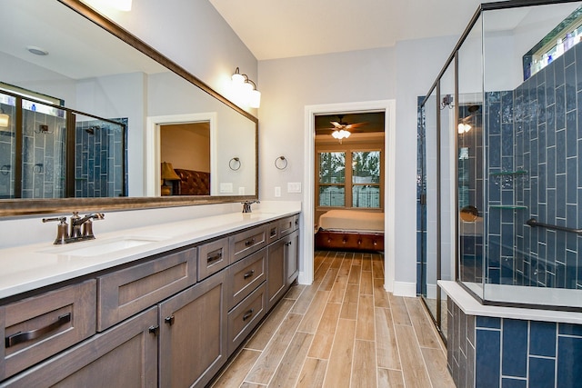 full bathroom with a sink, ensuite bathroom, a stall shower, and a healthy amount of sunlight