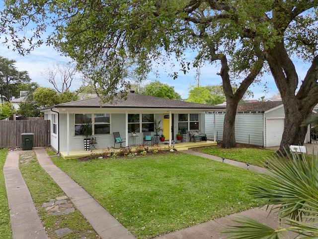 1211 35th St, Galveston, TX 77550 - rear view of house featuring fence, a shingled roof, a yard, covered porch, and a garage