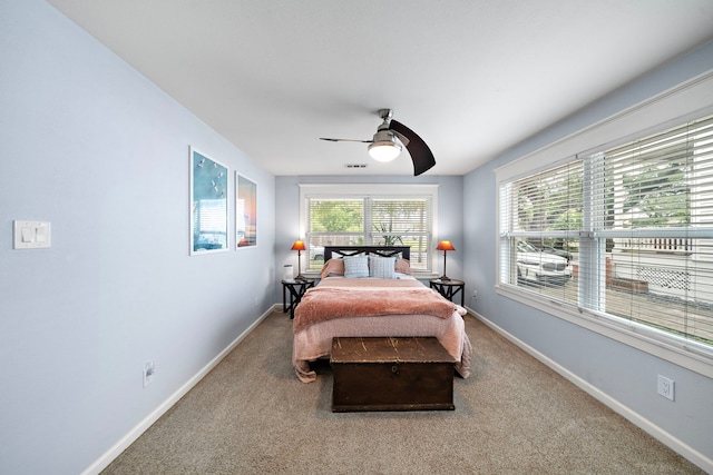 1211 35th St, Galveston, TX 77550 - bedroom with baseboards, a ceiling fan, and carpet flooring