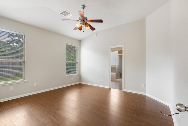 unfurnished room featuring wood finished floors, visible vents, and a wealth of natural light