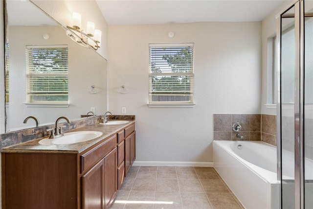 bathroom featuring plenty of natural light, baseboards, and a sink