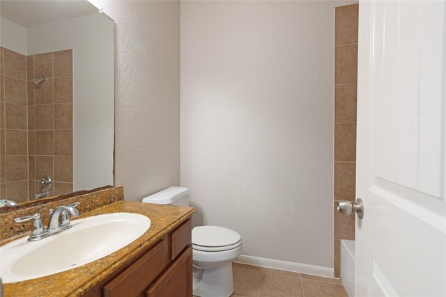 full bathroom with toilet, baseboards, shower / bath combination, tile patterned flooring, and vanity
