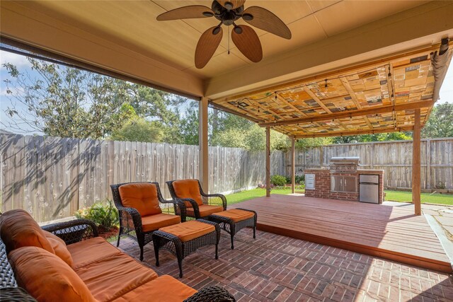 exterior space with exterior kitchen and a ceiling fan