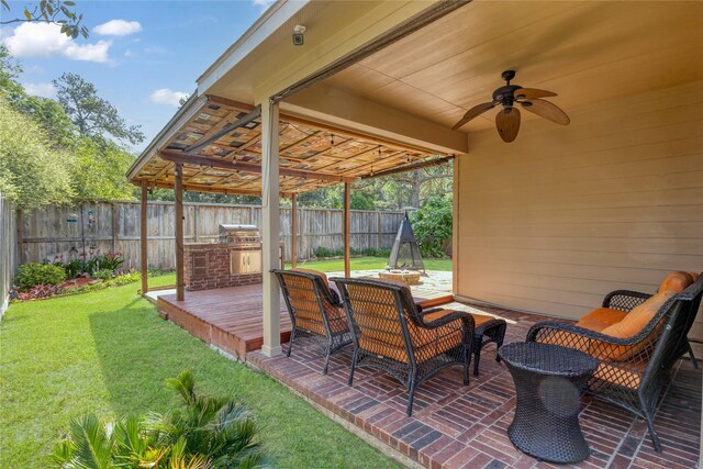 view of patio with a wooden deck, a fenced backyard, a ceiling fan, and area for grilling