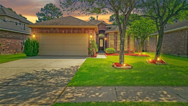 view of front facade featuring brick siding, concrete driveway, a front lawn, and a garage