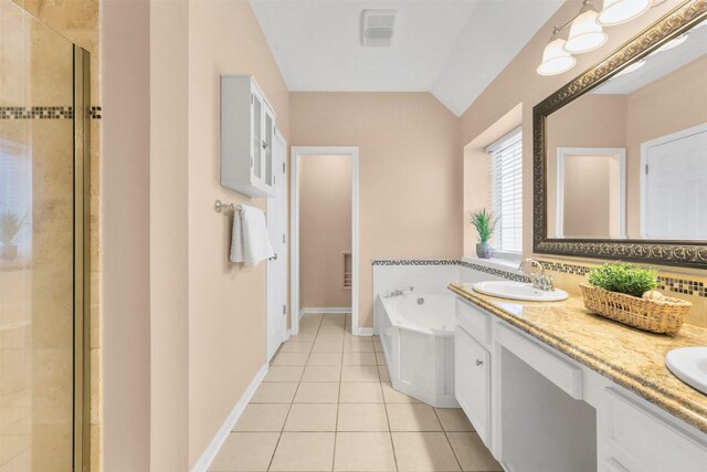full bathroom featuring a shower stall, tile patterned flooring, vaulted ceiling, a sink, and a garden tub