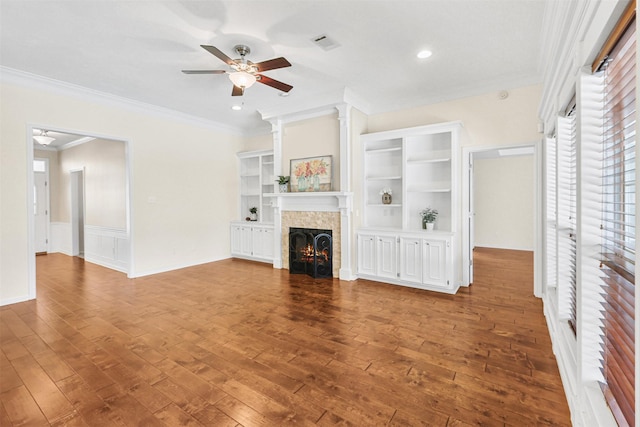 unfurnished living room with visible vents, a ceiling fan, crown molding, hardwood / wood-style flooring, and a lit fireplace