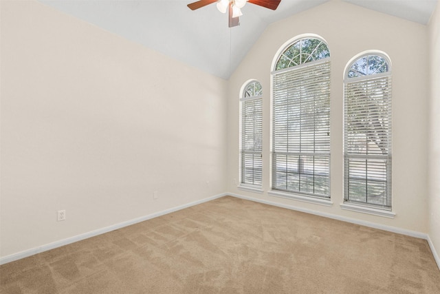 unfurnished room featuring light colored carpet, ceiling fan, baseboards, and vaulted ceiling