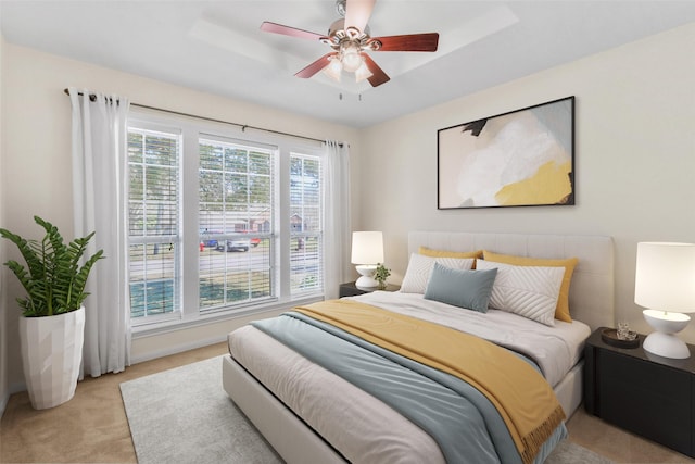 bedroom featuring light carpet and a ceiling fan