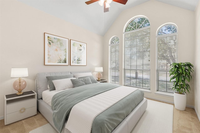 bedroom with baseboards, vaulted ceiling, carpet flooring, and a ceiling fan
