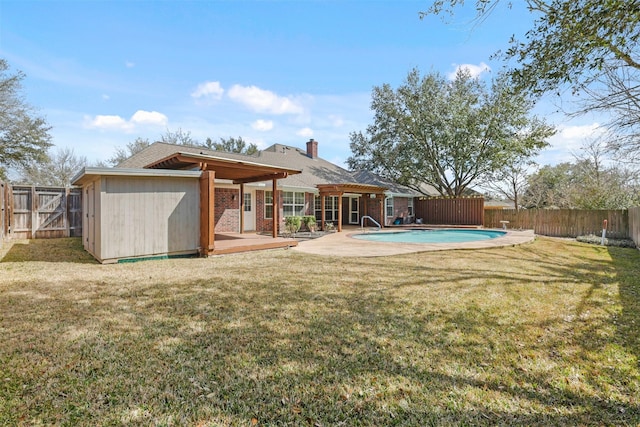 view of pool with a fenced backyard, a fenced in pool, a storage shed, and a lawn