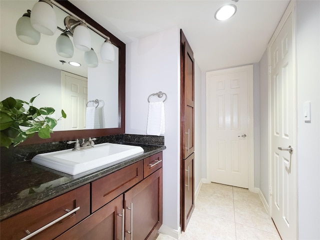 bathroom featuring baseboards, vanity, and tile patterned flooring