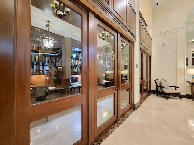 interior space featuring arched walkways and french doors