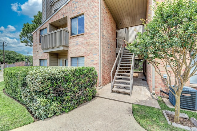 2023 Gentryside Dr Unit 508, Houston, TX 77077 - view of building exterior featuring central AC and stairs