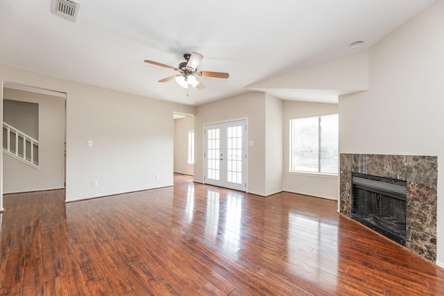 2023 Gentryside Dr Unit 508, Houston, TX 77077 - unfurnished living room with wood finished floors, a tiled fireplace, a ceiling fan, and visible vents