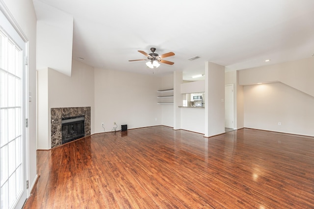2023 Gentryside Dr Unit 508, Houston, TX 77077 - unfurnished living room featuring a premium fireplace, wood finished floors, visible vents, and ceiling fan