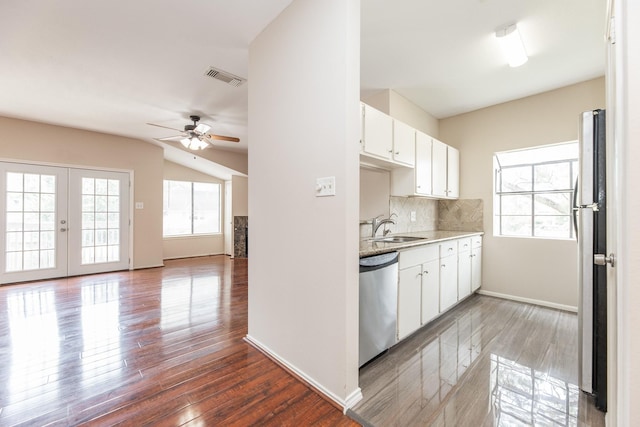 2023 Gentryside Dr Unit 508, Houston, TX 77077 - kitchen with a sink, visible vents, white cabinetry, wood finished floors, and appliances with stainless steel finishes