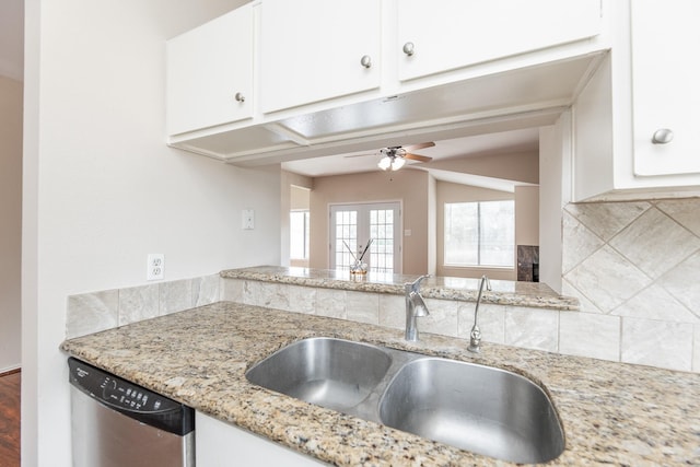 2023 Gentryside Dr Unit 508, Houston, TX 77077 - kitchen with stainless steel dishwasher, a sink, backsplash, white cabinetry, and light stone countertops