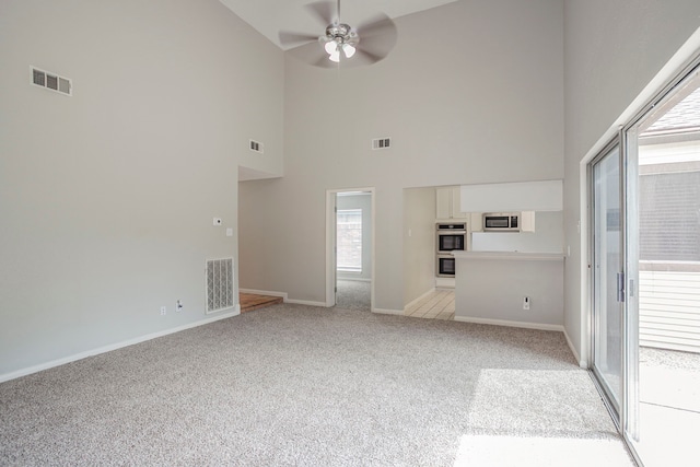 5893 Southern Hills Dr, Houston, TX 77069 - unfurnished living room with visible vents, high vaulted ceiling, and light carpet