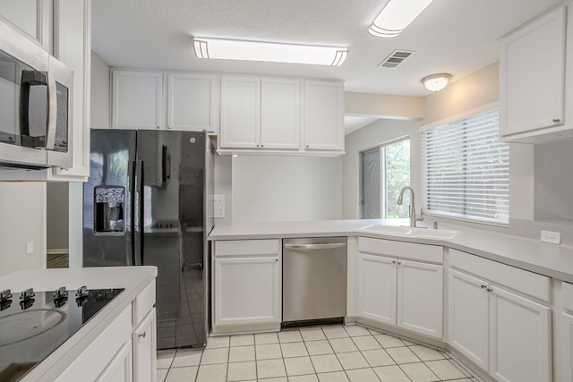 5893 Southern Hills Dr, Houston, TX 77069 - kitchen with black appliances, a sink, visible vents, and white cabinets