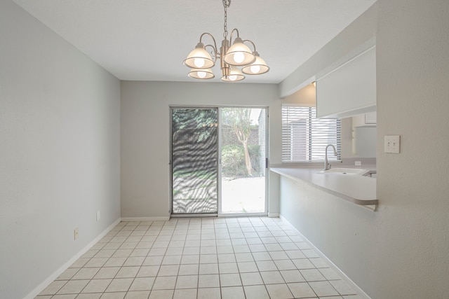 5893 Southern Hills Dr, Houston, TX 77069 - unfurnished dining area with light tile patterned floors, an inviting chandelier, baseboards, and a sink