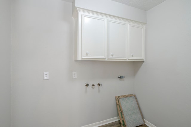 5893 Southern Hills Dr, Houston, TX 77069 - clothes washing area with hookup for an electric dryer, baseboards, cabinet space, and hookup for a washing machine