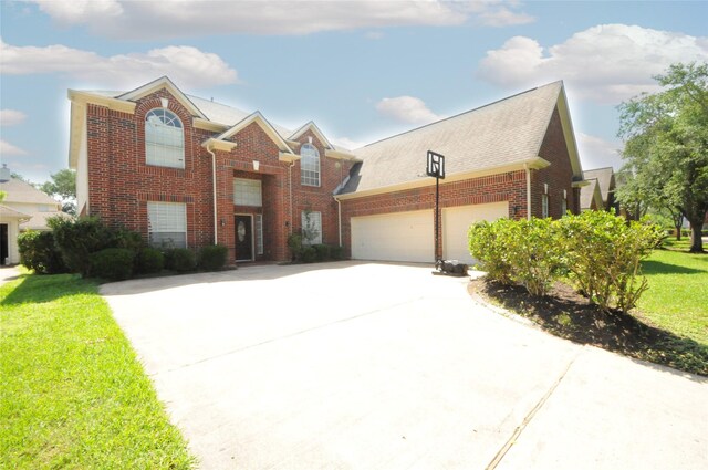 2631 Plantation Hollow Ct, Missouri City, TX 77459 - traditional-style house featuring brick siding, concrete driveway, a garage, and a front yard