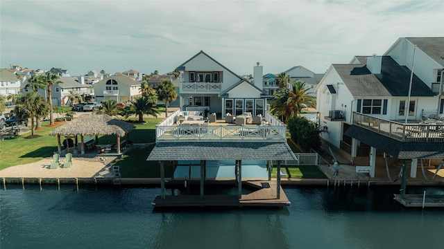 dock area with a gazebo, a residential view, a balcony, and central AC