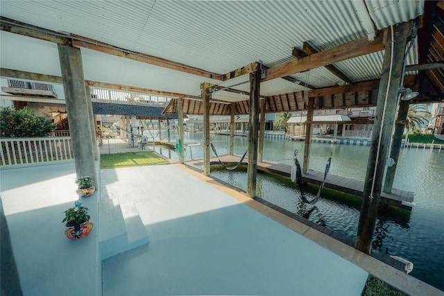 dock area featuring boat lift and a water view