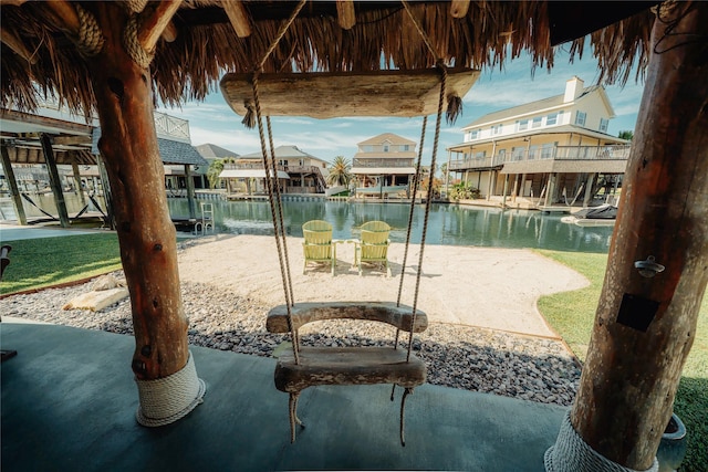 view of patio with a residential view and a water view