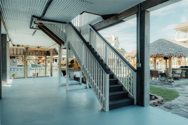 stairs with finished concrete flooring and healthy amount of natural light