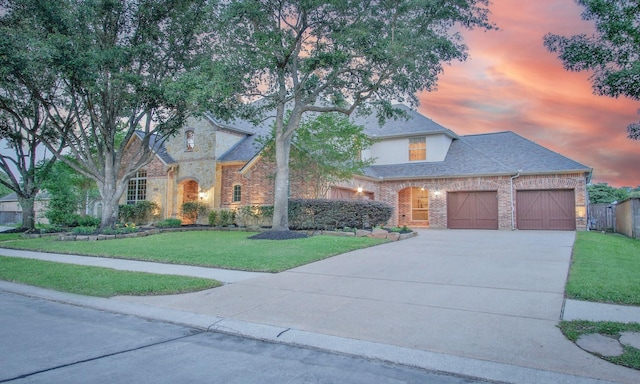 14622 Lindale Rose Ln, Humble, TX 77396 - view of front of home with driveway, an attached garage, a front yard, brick siding, and roof with shingles