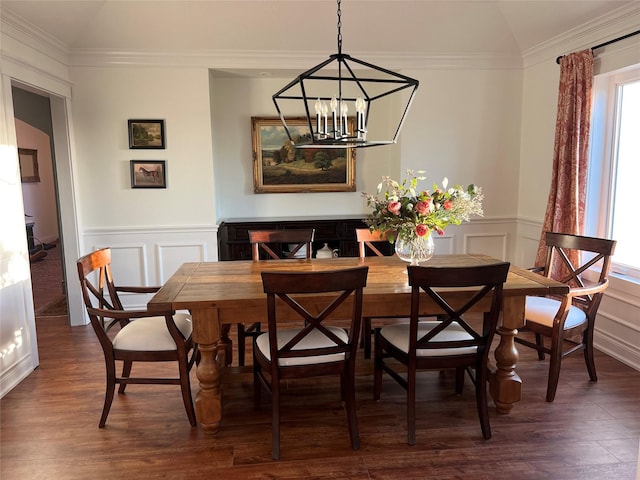 dining space with a decorative wall, a chandelier, and dark wood-type flooring
