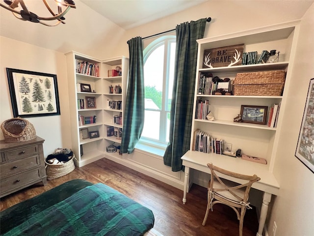 interior space featuring vaulted ceiling, wood finished floors, baseboards, and an inviting chandelier