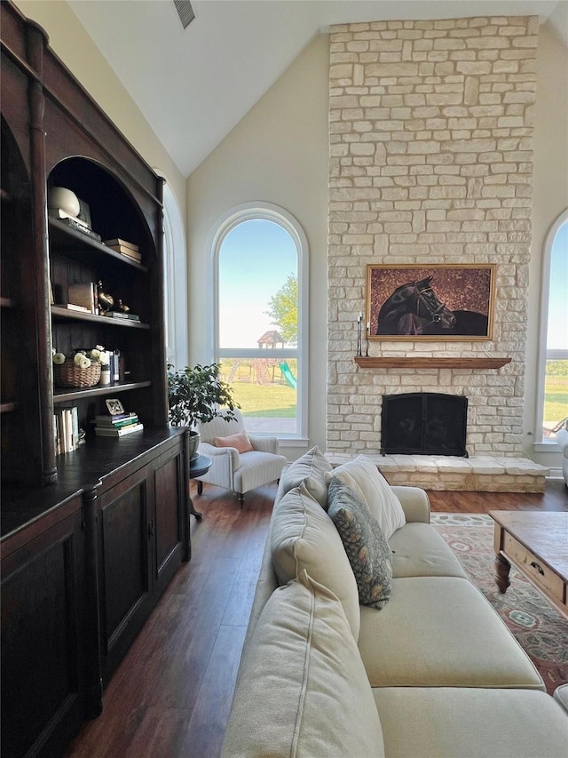 living room with lofted ceiling, a large fireplace, and dark wood-style floors