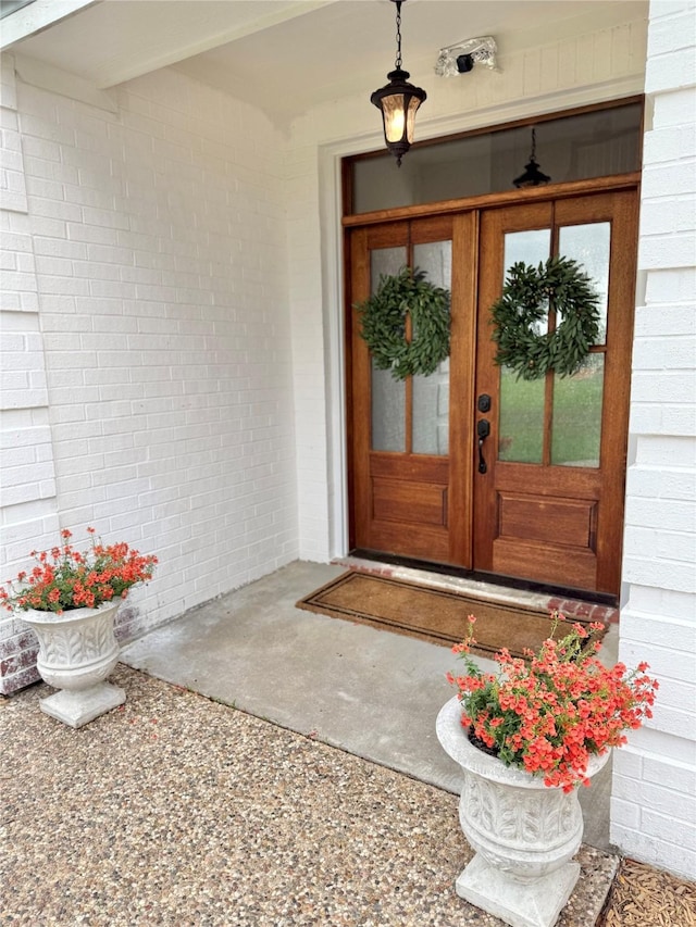 doorway to property with brick siding and french doors