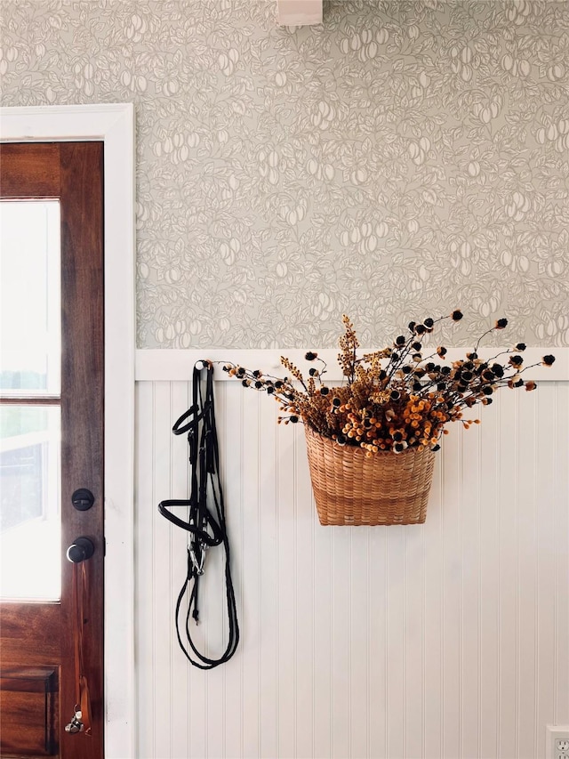 details featuring wallpapered walls and a wainscoted wall