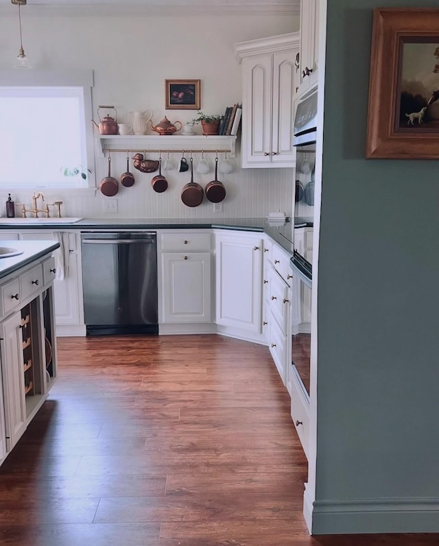 kitchen with white cabinets, stainless steel dishwasher, open shelves, and wood finished floors