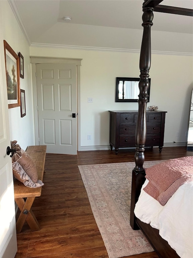 bedroom with dark wood-type flooring, baseboards, and ornamental molding